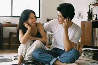 Couple listening to custom vinyl records on the living room floor